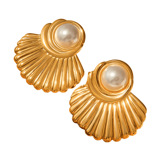Gold earrings with pearl centers on a white background