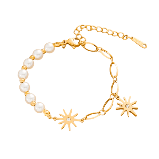 Gold bracelet with pearl beads and sun-shaped charms on a white background