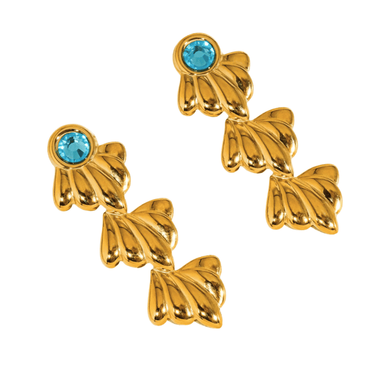 Gold earrings with blue gemstones on a white background