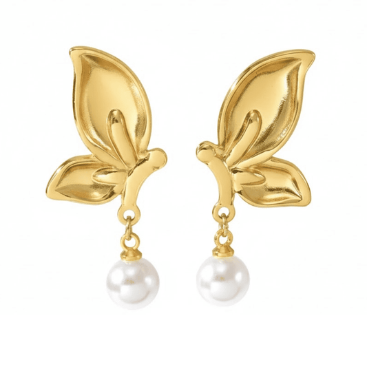 Gold leaf earrings with pearl drops on a white background