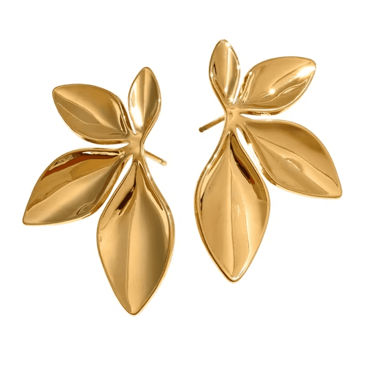 Pair of gold leaf-shaped earrings on a white background