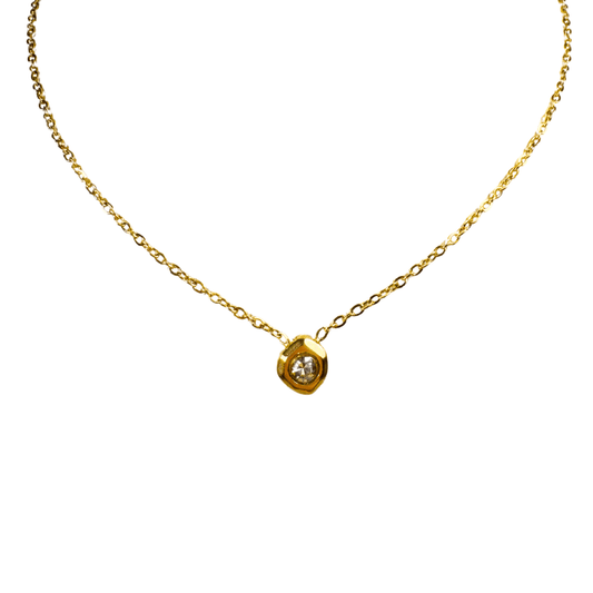 Gold necklace with a small pendant on a white background