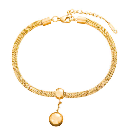 Gold bracelet with a round pendant on a white background