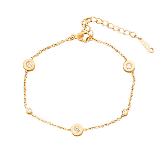 Gold bracelet with circular charms on a white background