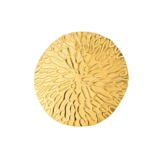 Gold circular decorative item with textured surface on a white background