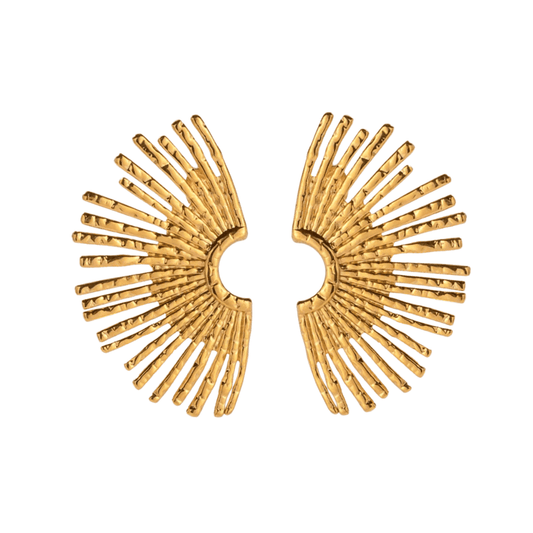 Gold sunburst earrings on a white background