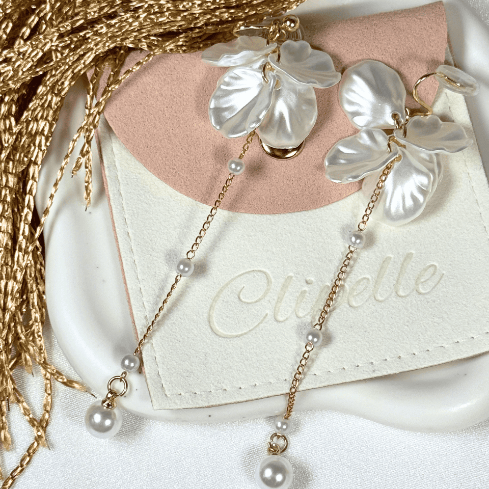 Pearl necklace with leaf-like pendants on a Clibelle branded card.
