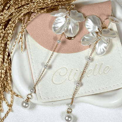 Pearl necklace with leaf-like pendants on a Clibelle branded card.