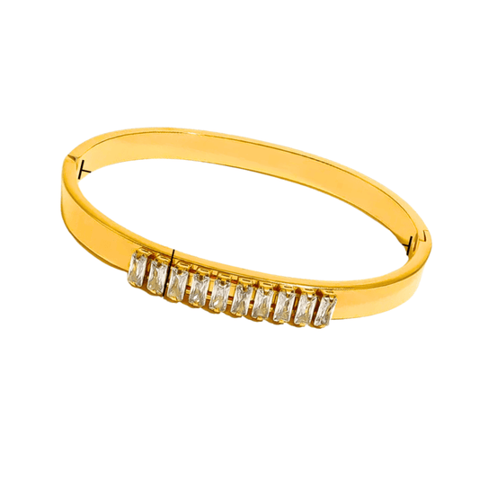 Gold bracelet with diamond accents on a white background