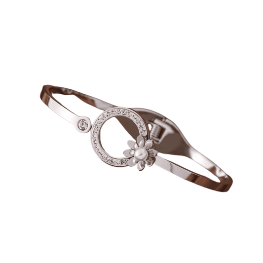 Silver bracelet with floral design and gemstones on a white background
