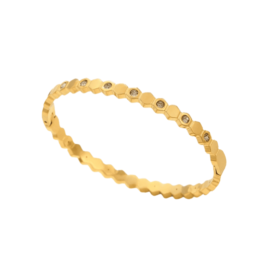 Gold bracelet with hexagonal links on a white background