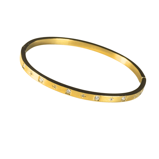Gold bracelet with embedded diamonds on a white background