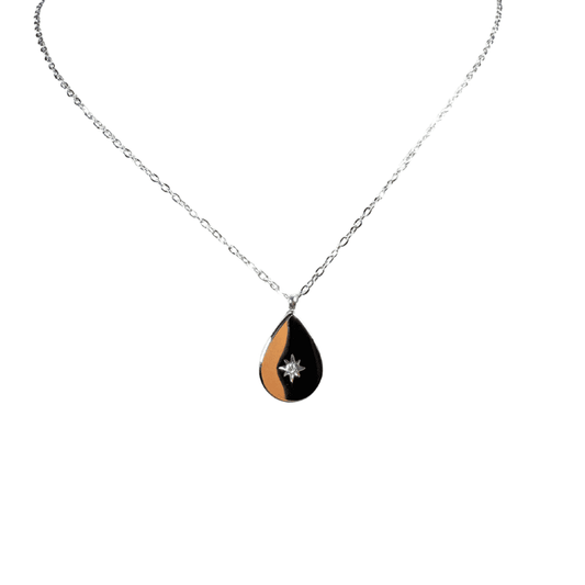 Teardrop-shaped pendant necklace with black and gold design on a white background