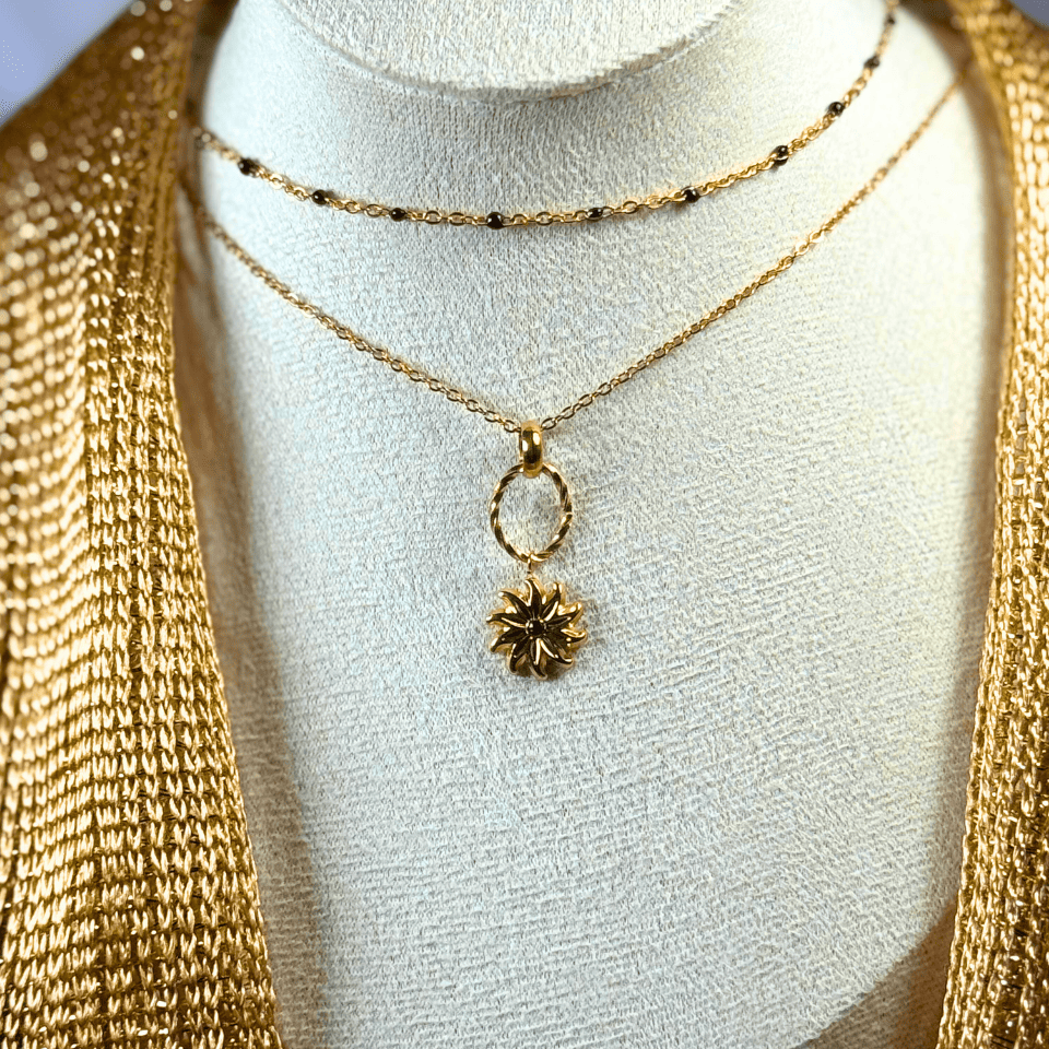 Gold necklace with a pendant on a mannequin bust