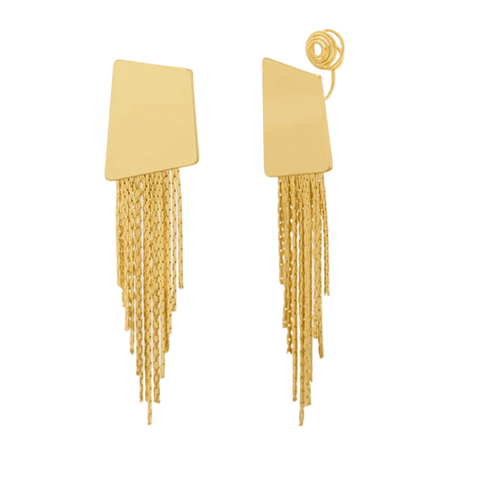Gold fringe earrings on a light pink background