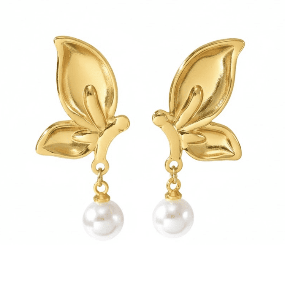 Gold leaf earrings with pearl drops on a white background