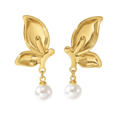 Gold leaf earrings with pearl drops on a white background
