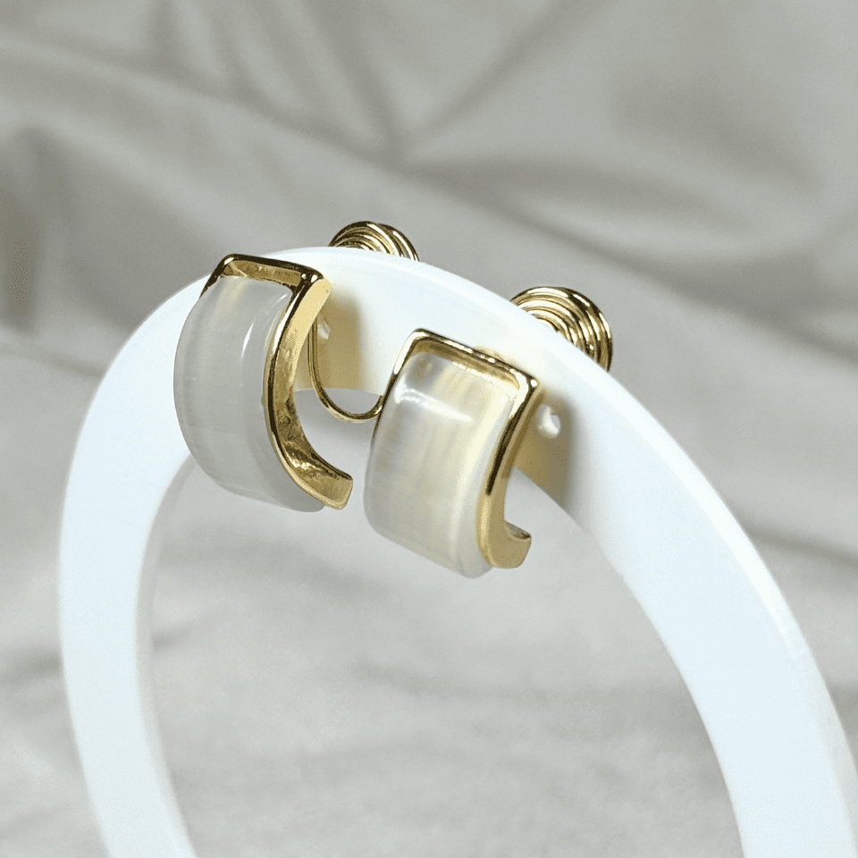 White circular object with gold accents on a neutral background