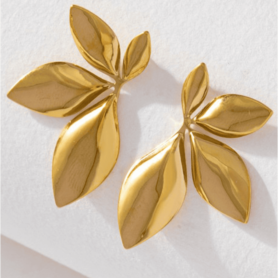 Pair of gold leaf-shaped earrings on a white background