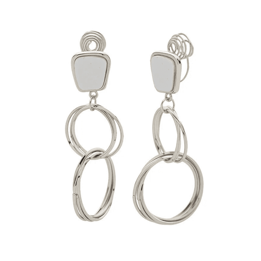 Pair of silver earrings with circular designs on a white background