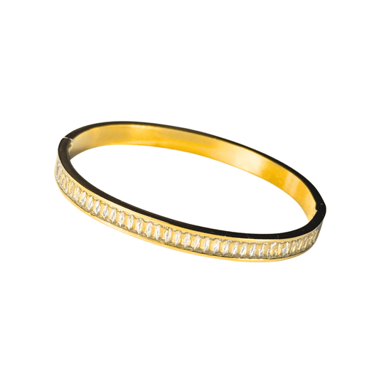 Gold bracelet with clear stones on a white background