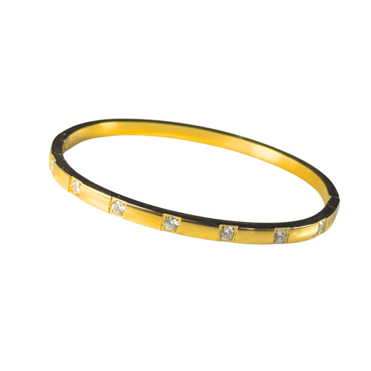 Gold bracelet with small diamonds on a white background