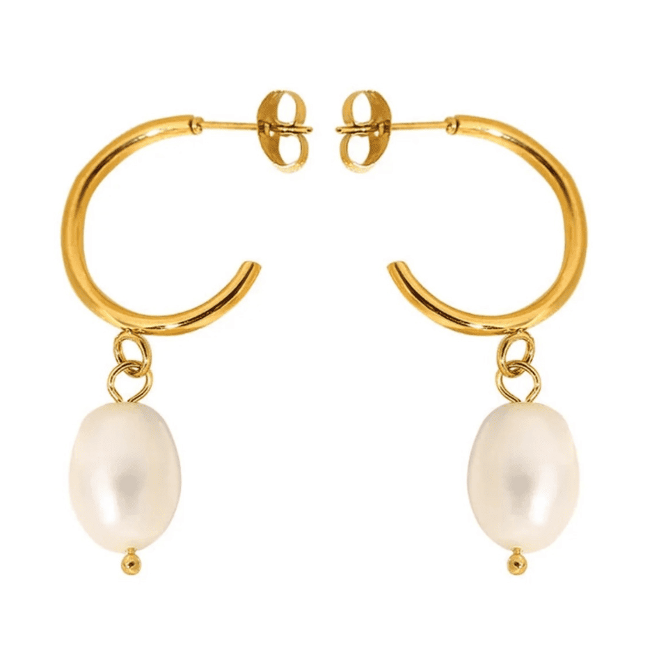 Gold hoop earrings with pearl charms on a white background